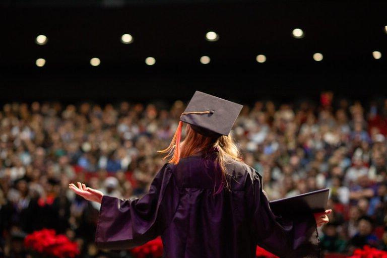 A graduate looks out to the crowd during commencement ceremonies.